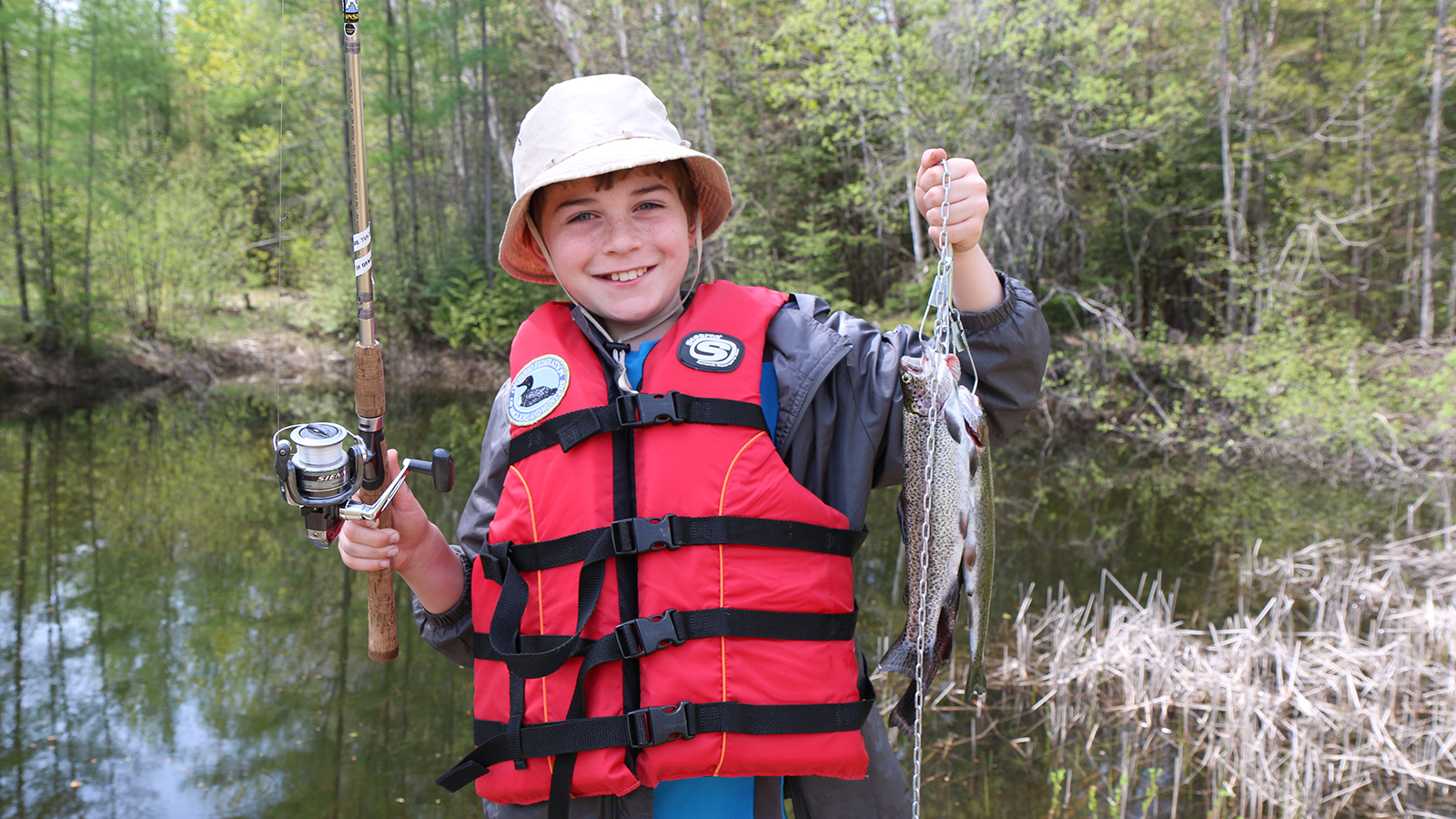 Young angler showing off fish he caught