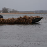 Waterfowl hunting with duck blind boat