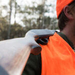 Man in hunter orange with shotgun