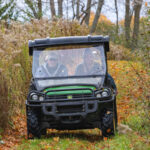 Riders in a side by side on a trail