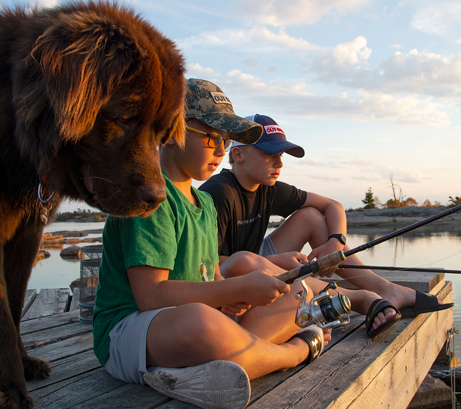 Kids and Dog on Dock Fishing